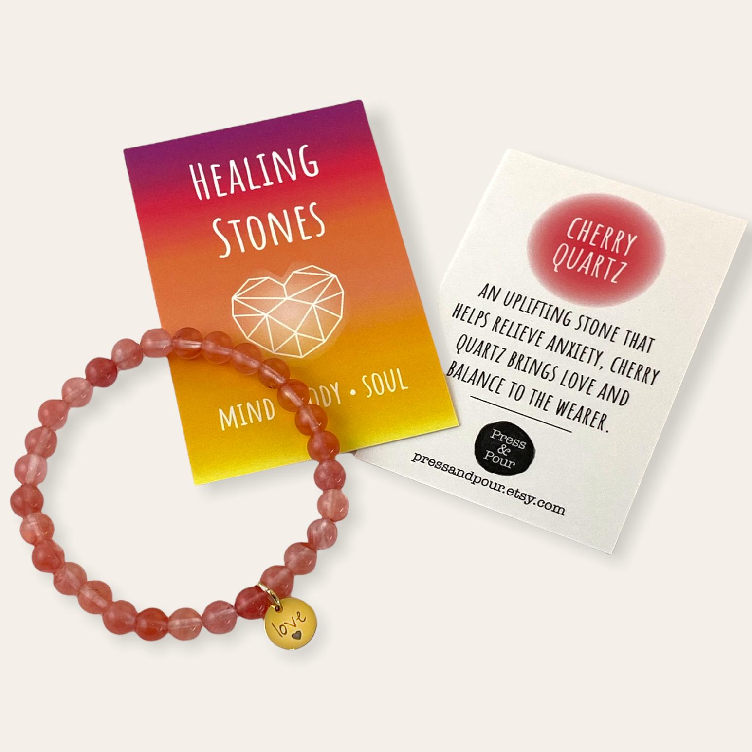 Cherry quartz bracelet with informational cards on a white background