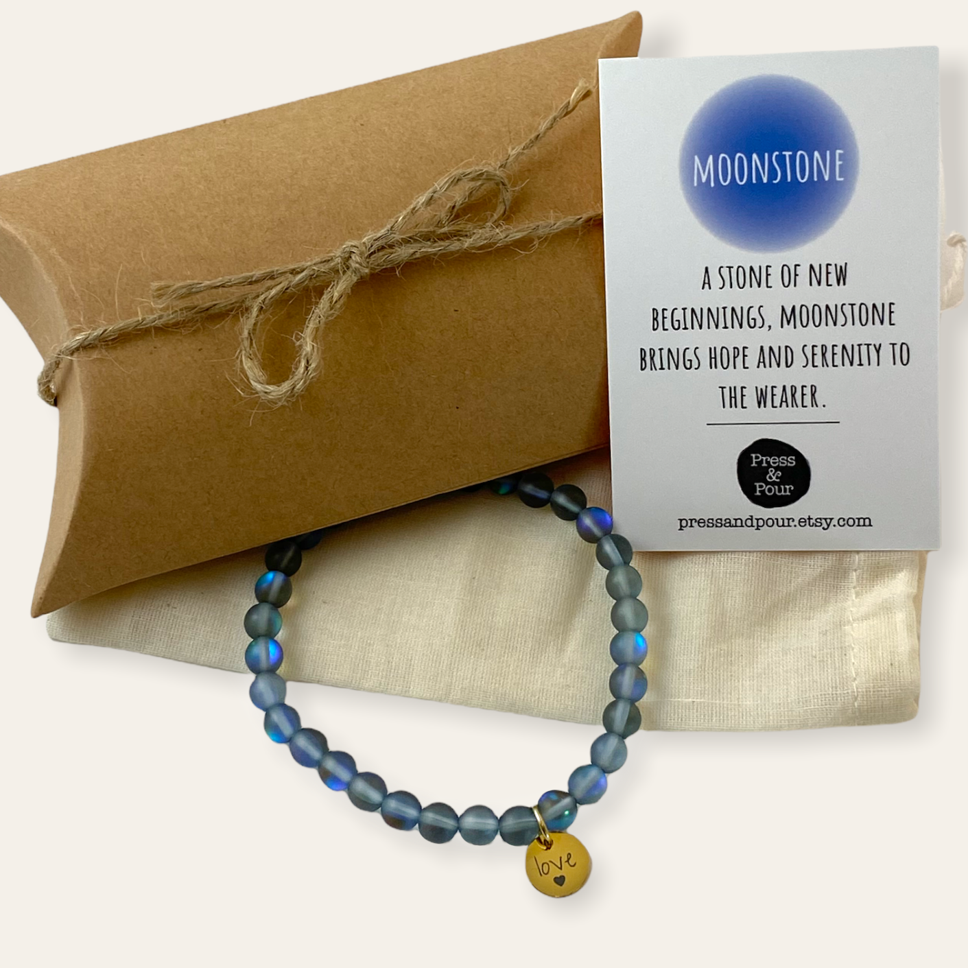 Blue beaded bracelet with a card on a beige background
