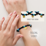 Bracelet with healing stones on a wrist, with a hand holding it up.