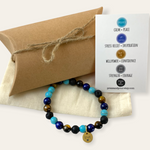 Beaded bracelet with a card and gift box on a white background